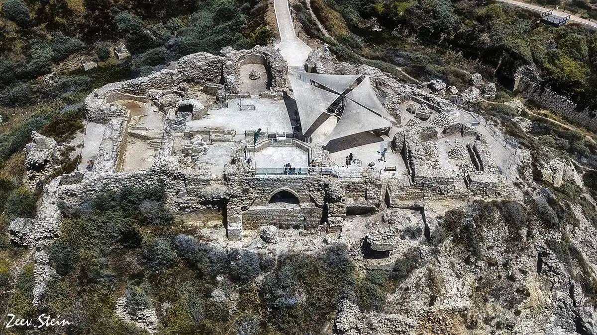 Aerial view of the Crusader fortress ruins and shaded visitor area at Apollonia National Park, Herzliya