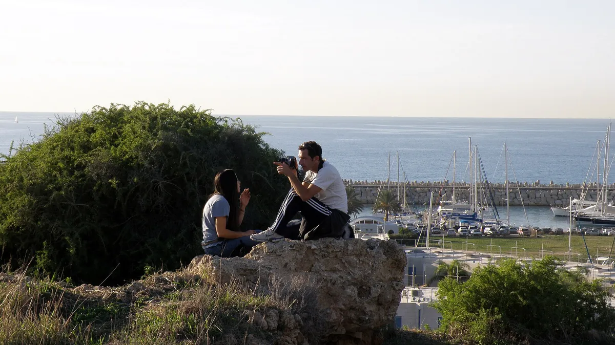 Visitors on the kurkar hill of Tel Michal overlooking Herzliya Marina and the sea